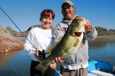 Lucy Salagado shows off a bass she caught on a lizard while fishing with Anglers Inn International at Lake Mateos near Mazatlan, Mexico.  (Photo by John N. Felsher)
