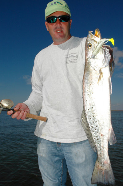 Capt. Beau Weber of Capt. Phil Robichauxs Guide Service in Lafitte, La., shows off a speckled trout he caught on an Attraxx Mystic Shrimp in the marshes near Lafitte, La. (Photo by John N. Felsher)