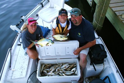 The Wood family with their catch of pompano, white trout, and ground mullet aboard TEAM BRODIE CHARTERS