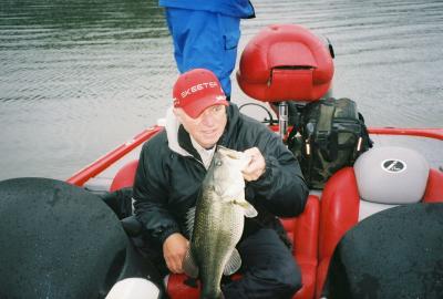 pro guide Joe Joslin on a recent rainy day with an 8 (plus) pound largemouth that hit a jig n pig in 15 feet of water.