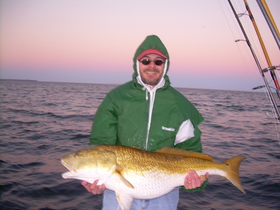 Joe with a Bull Red - what a nice sunset!!