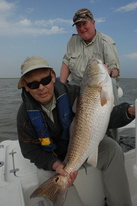 Dee helps Alan hold up this fish after Alan battled this Red