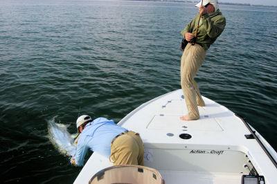 Capt. Rick Grassett lands Rick Happle's fly caught Tampa Bay tarpon.