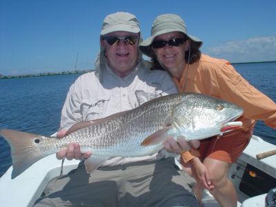 John Freeman, Jr., from Venice, FL,  with daughter, Chris Ryan, and one of more than 20 reds they caught and released on CAL jigs with shad tails while fishing Sarasota Bay with Capt. Rick Grassett.