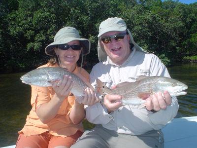 John Freeman, Jr., from Venice, FL,  with daughter, Chris Ryan, and a redfish double that they caught and released on CAL jigs with shad tails while fishing Sarasota Bay with Capt. Rick Grassett.