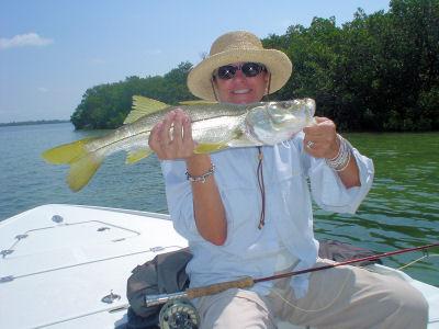 Nini Seaman, from CA, with a nice snook, her 1st on a fly, caught and released while fishing Sarasota Bay with Capt. Rick Grassett.
