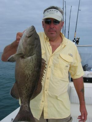 Pat owner of  Sully's Marina with a 10 lb Grouper