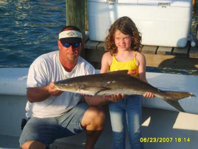 Capt. Rob Ward and daughter Savannah with a cobia they caught.