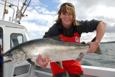The photo of the week shows Jacqueline Pendlington with an extremely bright Chinook (King) Salmon landed while ocean fishing.  Jacqueline is the wife of Mark Pendlington producer/host of Sportfishing BC television series.  This nice photo is a reminder we