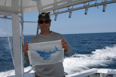 Proud of his sailfish, Bing prepares to hoist a release flag!
