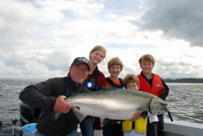 The photo of the week shows Mark Pendlington with his three kids Jenn, Brad, Michael and their friend Cole.  They were very proud to catch this big Chinook (King) Salmon while ocean fishing last summer.  Mark is the producer/host of the Sportfishing BC te