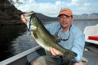 Dale Sorrell of Guthrie, Okla., shows off a bass he caught on a black and blue worm while fishing with Anglers Inn International at Lake El Salto near Mazatlan, Mexico.  (Photo by John N. Felsher)