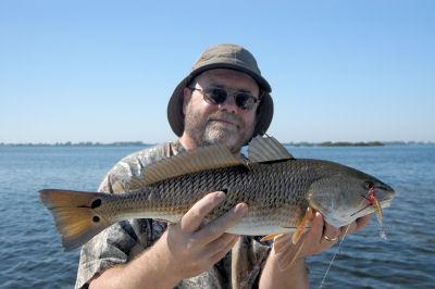 Reds should be feeding on shallow flats this month. Brad Johnson, from KY, caught this one on a CAL jig with a shad tail while fishing with Capt. Rick Grassett