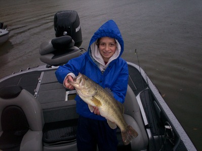 A rainy, summer day produced this big bass for a young and very happy angler!