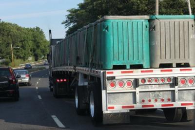 Iced down Menhaden filled Insulated fish containers, strapped to a flatbed for a road trip from NJ to New England\'s Lobster fishery