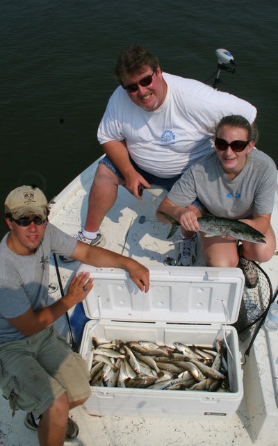 The Ed Perry group with a box of white trout, ground mullet, Spanish mackerel, and speckled trout
