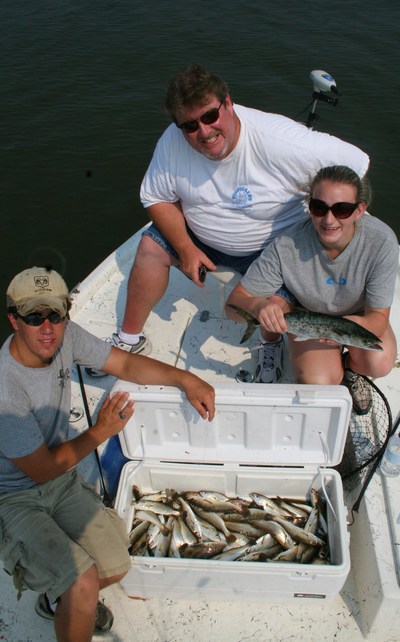 The Ed Perry group with a box of white trout, ground mullet, Spanish mackerel, and speckled trout