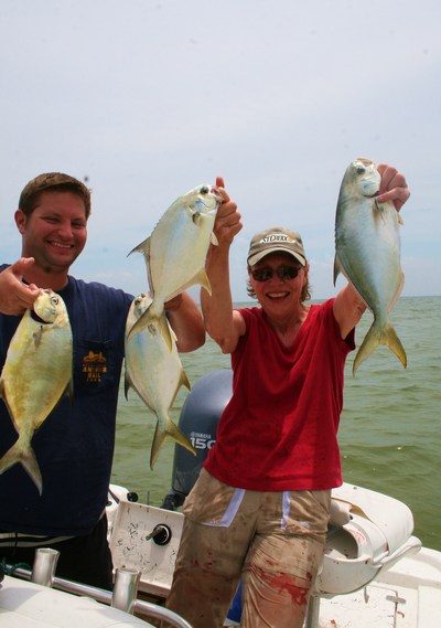 Blake Lacy and Jill J. Easton pose with some fine Florida pompano caught at Mississippi's barrier islands caught aboard TEAM BRODIE CHARTERS.