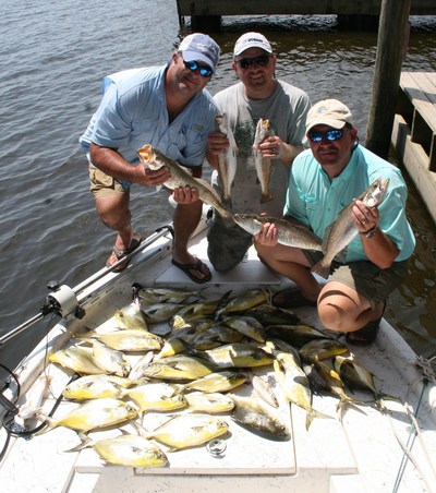 Scottie Ellison, Brad Bynum, and Mark Wilcox pose with pompano, and specks recently caught aboard TEAM BRODIE CHARTERS. Photo by Capt. Robert L. Brodie.