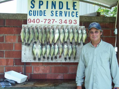 Tim with his limit of 25 crappie on a morning trip.  7-1-08