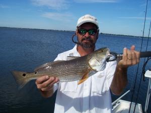 Pat Wells holding a slot size redfish....