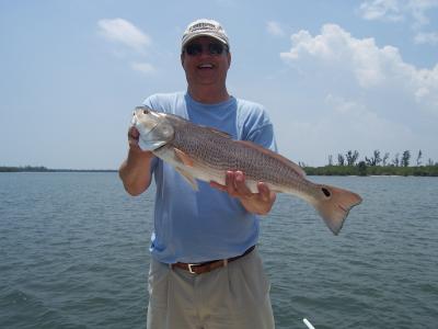 Tom Tait with one of his redfish caught on the flats...