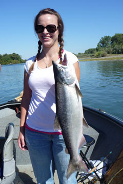 A happy client shows one of her fresh salmon.