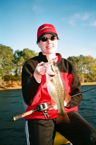 Lady angler catches a quality jigging spoon angler from a clear, deep south Toledo creek bed.