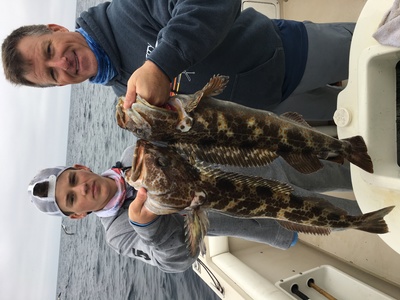 Chriss and his son with limits of lingcod and reds