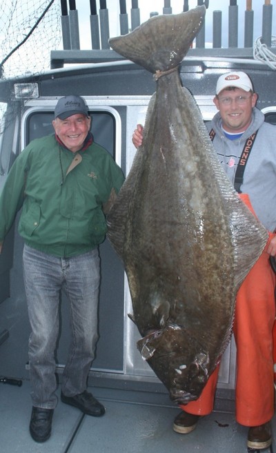 Ron Goode of Napa, Calif., and Capt. Andy Martin with a 235-pound halibut from Gustavus June 2.