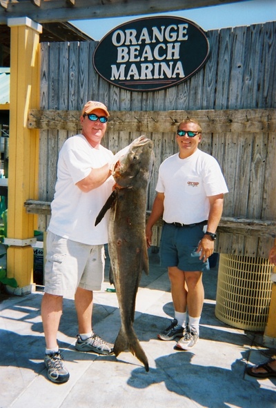 Angler Craig Komyati and Capt. Johnny Greene with a 99 pound Cobia