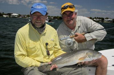 Brian McInnis and Capt. Rick Grassett, from Sarasota, FL, with a red that Brian caught on a fly while fishing Sarasota Bay with Capt. Rick.