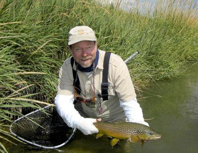 Capt. Rick Grassett, from Sarasota, FL, with a nice brown trout caught and released with a hopper fly pattern while fishing out of Crane Meadow Lodge, Twin Bridges, MT