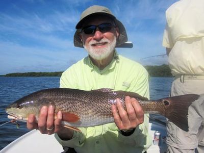 Chuck Hempfling, from IL, with a nice red caught on a CAL jig with a shad tail while fishing Gasparilla Sound with Capt. Rick Grassett.