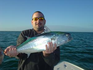 Bryan Gibson, from Sarasota, FL, with a little tunny caught in the coastal gulf out of Venice, FL, while fishing with his dad, Capt. Rick Grassett.