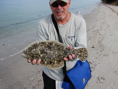Steve Gibson with a nice flounder caught on fly in the surf.