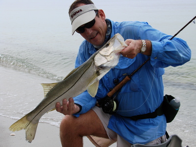 Scott Dempsey of Tampa admires a 29.5-inch snook he caught sight-fishing the surf.
