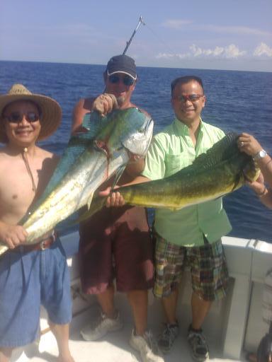 Happy guys holding Mahi