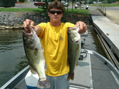 A happy young man with a pair of Guntersville Lake largemouth bass!