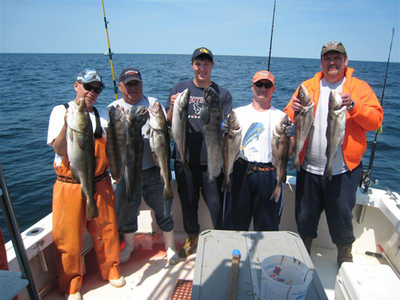 A happy group of fisherman aboard an open boat shared charter aboard RELENTLESS