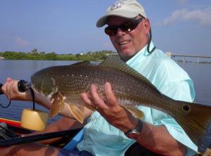 Kayak guide Steve Gibson shows off a redfish caught on a jerk worm near Lemon Bay.
