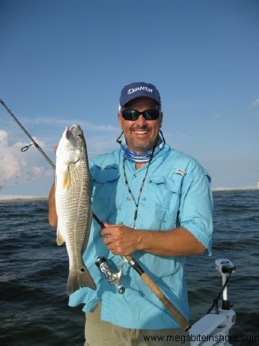 Capt. John with a nice slot red caugth on a Mann's Spoon