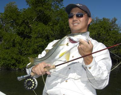 Jon Yenari with a Charlotte Harbor snook caught on a fly while fishing with Capt. Rick Grassett.