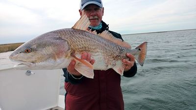 Mike Perez, from Sarasota, FL, with a big Louisiana red caught and released on a fly while fishing out of Hopedale, LA.
