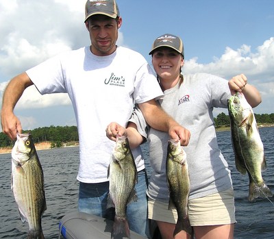 pic info: Louisiana anglers Mike Black and Alanna Heinrich with stripers, white bass and largemouth bass all caught on a south Toledo grass flat.  Photo by Joe Joslin Outdoors