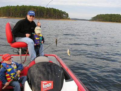 Grand kids on their first fishing trip spooning up some of Toledo's yellow bass