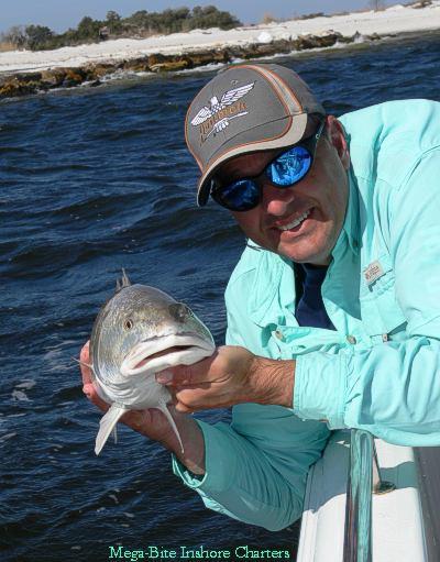 Capt. John releasing  a nice redfish