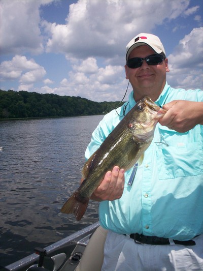 A happy client of Reeds Guide Service with a nice Guntersville lake bass!