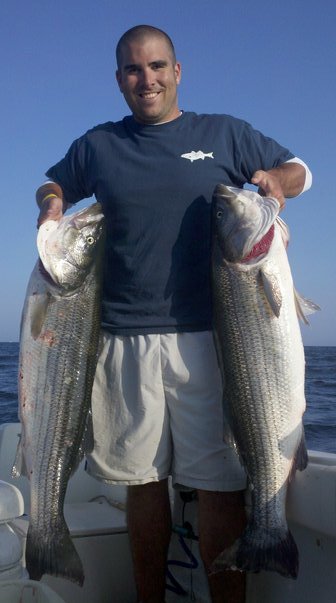 Brian with a pair of nice Cape Cod striped bass.