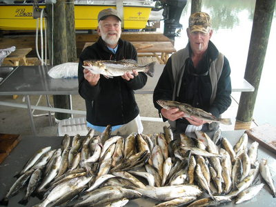 Skip and Donald Marks with the table full of speckled trout
